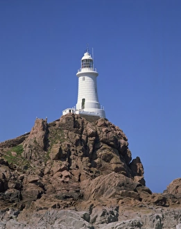 Jersey Prints: Lighthouse on rocks at Corbiere Point on the island of Jersey