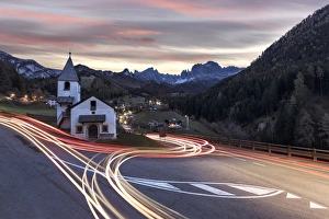 Lights of car trails around the Church of San Cipriano, Tires Valley, Dolomites, South Tyrol
