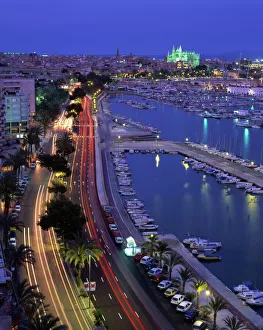 Lights at dusk, with boats in the marina and Palma cathedral across the bay