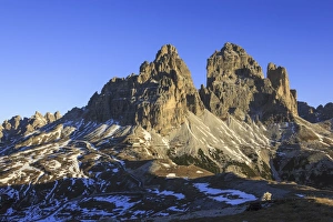 Jagged Prints: The lights of sunrise frames the Three Peaks of Lavaredo, Dolomites, Auronzo of Cadore