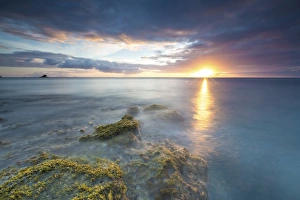 Antigua Prints: The lights of sunset are reflected in the blue sea Hawksbill Bay