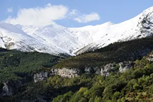 Rock Cliffs Prints: Limestone escarpments above Escuain gorge with snow covered high Pyrenees peaks in the background