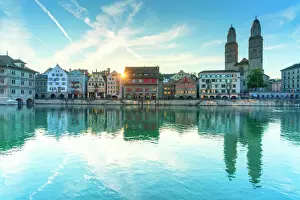 Flowing Water Prints: Limmatquai and Grossmunster Cathedral mirrored in Limmat River at dawn, Zurich