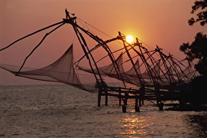 Fishing Net Prints: A line of Chinese fishing nets on the coast at sunset