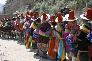 Tibetan Ethnicity Prints: Line of people wearing Tibetan traditional dress, Tongren, Qinghai Province, China, Asia