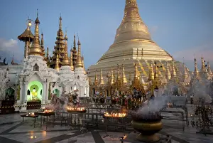 Religious Offering Prints: Lit candles placed by devotees at sunset at the Shwesagon Pagoda, a 2500 year old