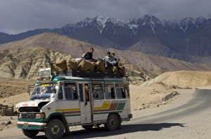 Buses Prints: Loaded mini bus with half open engine lid and people