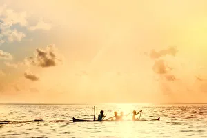 Kids Prints: Local boys on a wooden canoe at sunset, Banda, Maluku, Spice Islands, Indonesia