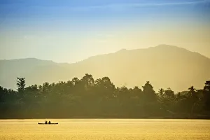 Fisherman Prints: A local fisherman in a traditional canoe, Banda, Maluku, Spice Islands, Indonesia