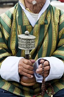 Bhutan Prints: Local man holding a prayer wheel and beads, Paro District, Bhutan, Asia