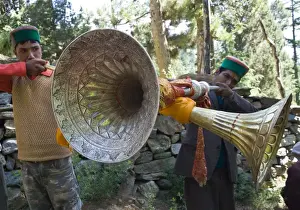 Two Men Prints: Two local men blowing large traditional wind instruments