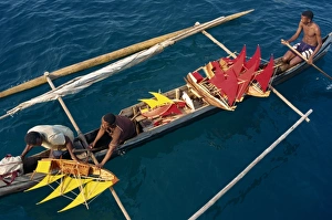 Model Prints: Local men transport model boats by canoe to market
