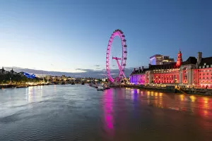 Ferris Wheel Collection: The London Eye lit up pink during blue hour, and River Thames, London, England