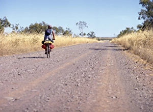 Loneliness Prints: Lone cyclist on country road, Western Australia, Australia, Pacific