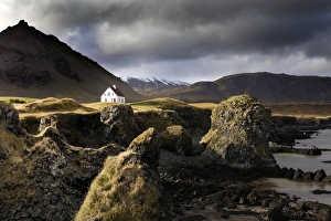 Lone house and sea stacks in stormy weather, Arnastapi, Snaefellsnes Peninsula, Iceland