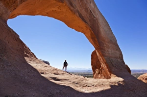 50 54 Years Prints: Lone tourist hiker at Wilson Arch