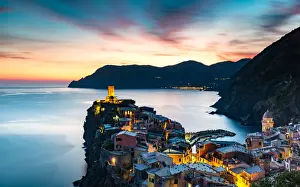 Slow Shutter Prints: Long exposure at blue hour to capture the end of a stunning sunset and the lights of the old town