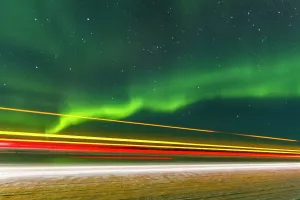 Northern Prints: Long exposure captures Jeep lights beneath the aurora borealis over Great Slave Lake in Canada at night