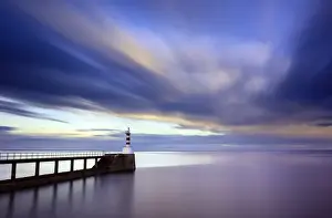 Northumberland Prints: Long exposure image of Amble Lighthouse with streaky clouds and smooth sea, Amble