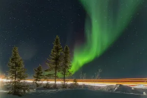 Northern Prints: Long exposure of Jeep lights and Aurora Borealis over Great Slave Lake at night in Northwest Territories Canada