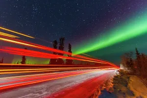 Northern Prints: Long exposure of Jeep lights with Aurora Borealis above Great Slave Lake in Northwest Territories Canada