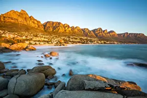 Slow Shutter Prints: Long exposure at sunset in Camps Bay with Table Mountain and its cable car on the left