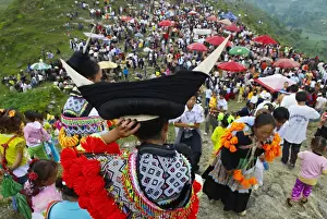 Crowded Prints: Long Horn Miao girls in traditional costumes celebrating summer Festival