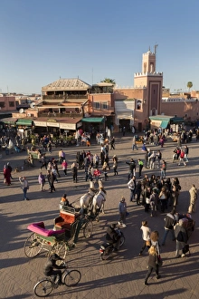 Cart Prints: Long shadows in the busy square of Place Jemaa el-Fna