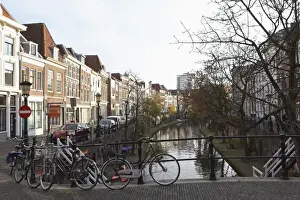 Bicycles Prints: Looking along the Catharijnsingel, bicycles stand on a bridge over a canal in Utrecht