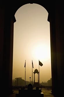 Looking at sunrise through the Sir Edwin Lutyens designed India Gate in New Delhi