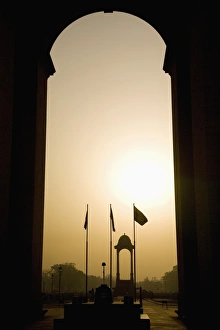 Looking at sunrise through the Sir Edwin Lutyens designed India Gate in New Delhi Looking at sunrise through the Sir Edwin Lutyens designed India Gate in New Delhi