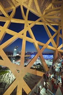 Images Dated 11th September 2008: Looking out to the Water Cube National Aquatics Center from The Birds Nest National Stadium