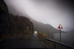 Road Sign Prints: Lorry on wet road beside fjord, Norway, Scandinavia, Europe