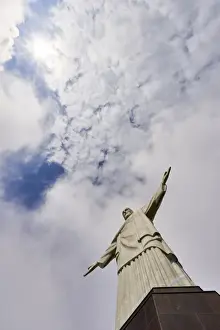 Arms Outstretched Prints: Low angle shot of the iconic statue of Christ the Redeemer on a cloudy day with sun