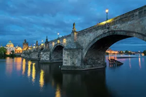What's New: Low angle view of arches of Charles Bridge at twilight, UNESCO World Heritage Site, Prague, Bohemia