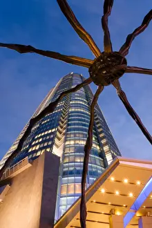 Roppongi Hills Prints: Low angle view at dusk of Mori Tower and Maman Spider sculpture