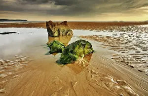 Tides Prints: Low tide view of rocks, rippled sand and water pools on the beach in Bigbury-on-Sea