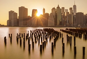 East River Prints: Lower Manhattan skyline, New York skyline, exposed wooden pier stumps, at sunset