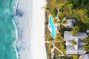 Swimming Pool Prints: Luxury resort with swimming pool on a palm fringed beach