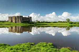 Pembrokeshire Prints: The magnificent ruins of Carew Castle reflected in the Mill Pond in spring