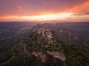 Autumnal Prints: A magnificient aerial view of the beautiful village of Civita di Bagnoregio during an autumn sunset