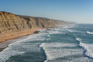 Sintra Prints: Magoito beach with surfers surfing on the sea waves, near Sintra, Portugal, Europe
