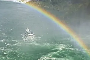 Rain Bow Prints: Maid of the Mist tour excursion boat under the Horseshoe Falls waterfall with rainbow at Niagara Falls