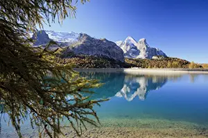 The majestic Marmolada Group and the Lake Fedaia with its turquoise waters, Dolomites, Italy, Europe