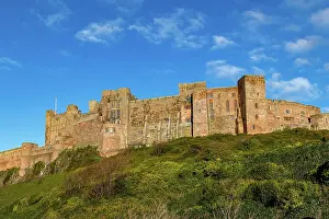Popular Prints: Majestic medieval castle on a hill with lush greenery under a clear blue sky
