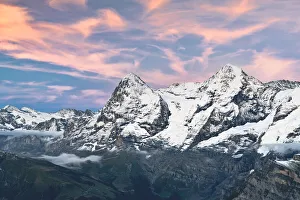 Jungfrau Prints: Majestic mountains Eiger and Monch under pink clouds at sunset, Murren Birg