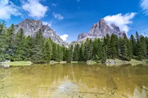 Mountain Pass Prints: Majestic rock peak of Tofana di Rozes mirrored in the clear water of lake Bai De Dones