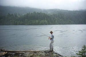 Images Dated 25th July 2009: Man, 30 years old, fishes on Ross Lake, North Cascades National Park, Washington