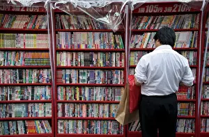 One Man Only Prints: Man browsing Japanese manga comic books at a shop in Osaka, Japan, Asia