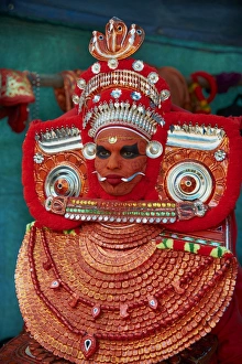 Man in costume representing a god at the Teyyam ceremony, near Kannur, Kerala, India, Asia